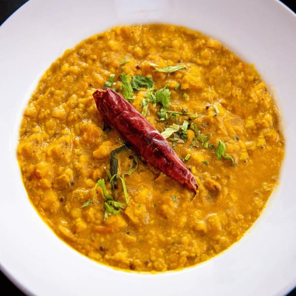 Ashoka Indian Restaurant's yellow dal, garnished with fresh cilantro and a dried red chili.