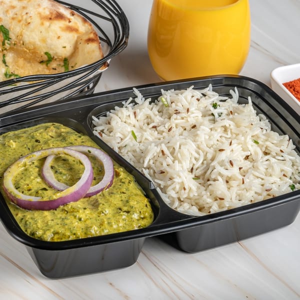 Ashoka Indian Restaurant's Indian meal with green curry, rice, naan, and a mango lassi.